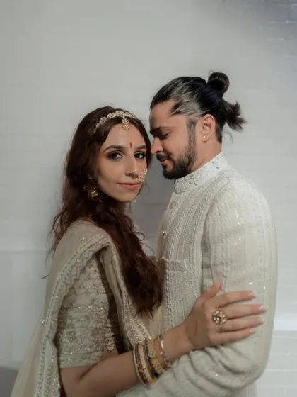 A classic and intimate portrait of the couple. The groom's man bun and the bride's elegant look make for a modern yet timeless wedding photo.