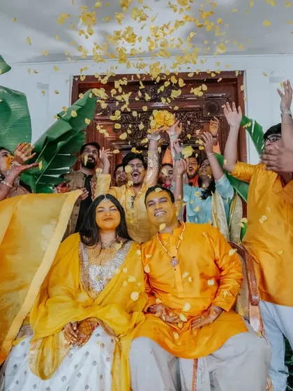The happy couple glowing in "yellove." We designed this Haldi setting to be both traditional and fresh, with a backdrop of rich greenery that beautifully complemented their yellow outfits.
