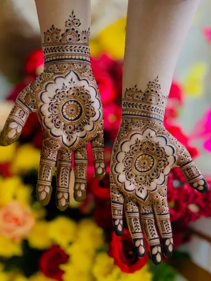 A beautiful and perfectly symmetrical mandala design, featuring a floral shape with negative space that makes the pattern pop.