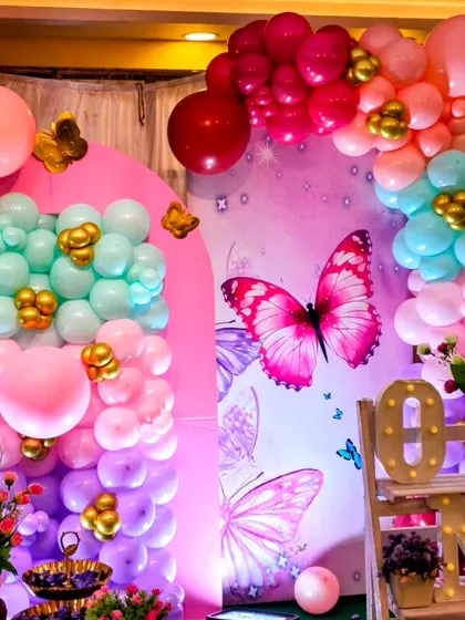A detail shot of the colorful balloon arch from a butterfly-themed party.