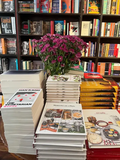 Stacks of our book at the launch event, surrounded by flowers. A beautiful sight.