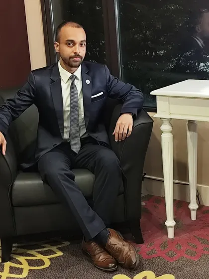 A formal portrait reflecting the serious and focused mindset required for both martial arts and professional speaking.