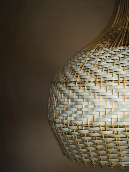 A close-up of the white and natural weave. The subtle chevron pattern adds a layer of sophisticated detail to this beautifully crafted lampshade.