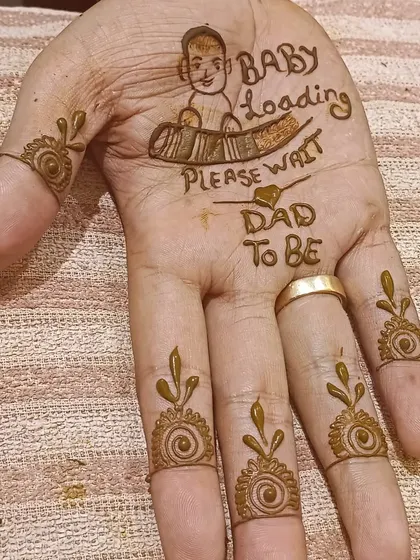 A simple and sweet mehendi for the father-to-be, with "Dad to be" and a "Baby Loading" graphic. It's a fun way for dads to join in the celebration.