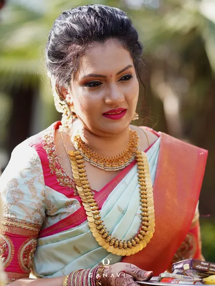Our gorgeous client Sanjana looks beautiful in her custom-designed blouse. The unique color combination of light blue and pink is highlighted by the delicate gold embroidery on the sleeves.