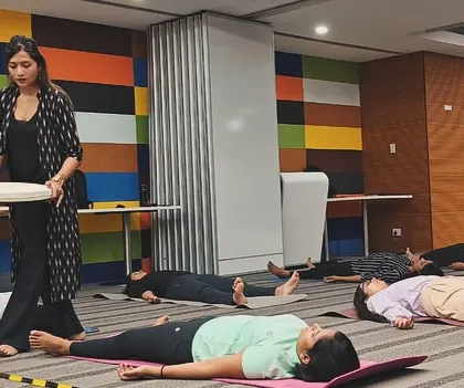 A closer view of me facilitating the sound bath at ABB. Moving around the room allows me to adjust the sound and energy flow based on the group's needs.
