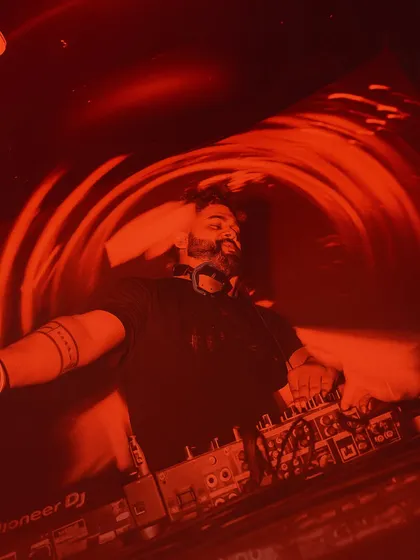 Another perspective of me lost in the music. The red vibes represent the passion and intensity I bring to my sets.