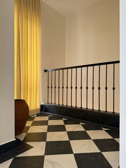 Golden hour? No, that’s just the curtain. A simple but elegant corner with a black and white checkered floor, terracotta pot, and a beautiful yellow curtain.