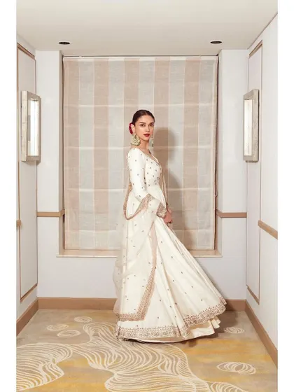 The full, flowing silhouette of the Jigar Mali anarkali. It's a look that commands attention with its grace and poise.