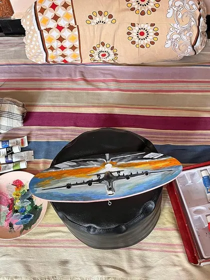 Here is a look at my setup for the airplane painting. A quick weekend project that was so much fun to create on this wooden canvas. You can see my paints, palette, and the artwork in progress.