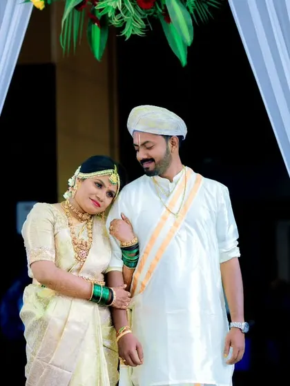 A quiet, tender moment between the newly married couple as they stand together, framed by white curtains.