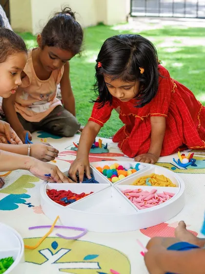 This sensory tray with different compartments is perfect for a group of children to explore together. It encourages sharing, communication, and collaborative play.