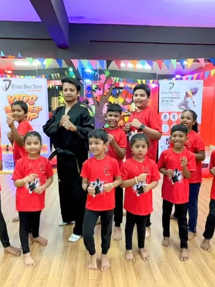 The Taekwondo team posing with their master after a powerful demonstration. Learning martial arts helps kids develop focus, respect, and physical strength.