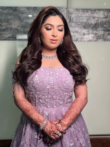 The soft waves add a touch of romance and glamour to this elegant reception look.