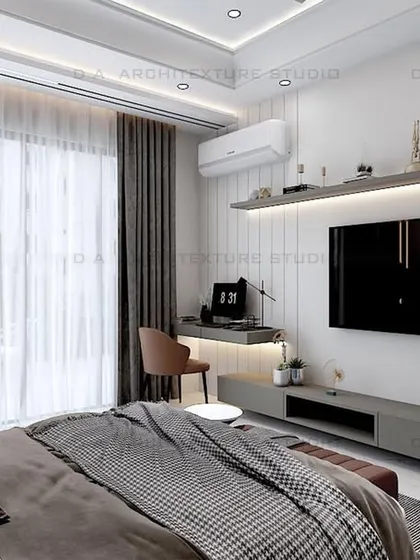 A view of the TV and study area in the same bedroom, showing how a workspace can be seamlessly integrated without disrupting the room's serene feel.