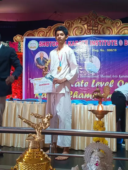 One of our dedicated students standing proudly with his medal and trophy after a successful performance at a state-level championship. His stance and confidence reflect the discipline learned in the dojo.