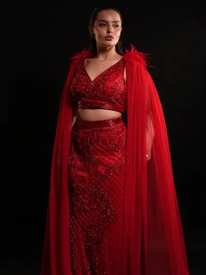 Where craftsmanship meets couture. This red straight-fit outfit with a dramatic cape from our High Ball Collection is elegance in every stitch.