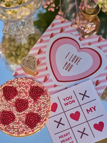 More of the custom-designed stationery, including the "I Love You" card and beaded coaster, reflecting the couple's playful personality.