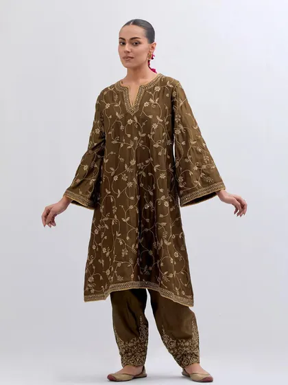 The full view of the olive green embroidered kurta set. The flared sleeves and matching embroidered trousers create a cohesive and elegant look that is perfect for any semi-formal occasion.