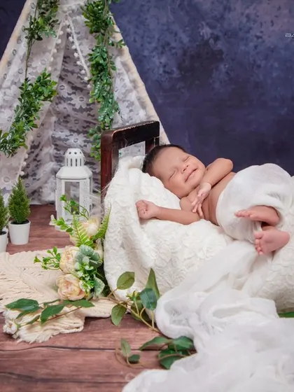 A smile in his sleep. This baby is dreaming sweet dreams in a magical, nature-inspired campsite.