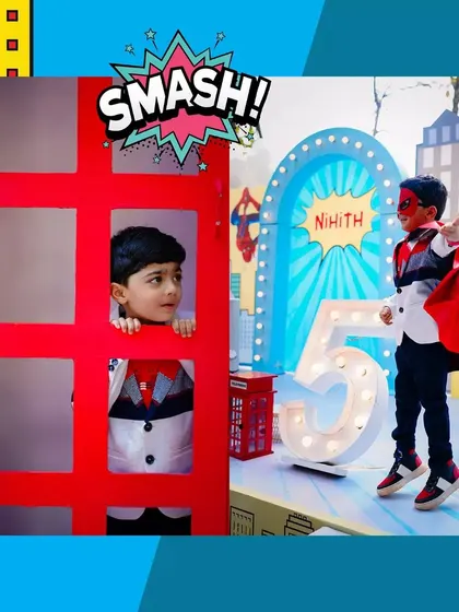 A candid shot of the birthday boy, with his face painted, peeking through a prop at his superhero party. It's these playful moments we love to create.