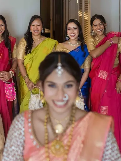 A fun, creative shot with the bride in the foreground (out of focus) and her smiling bridesmaids lined up behind her.