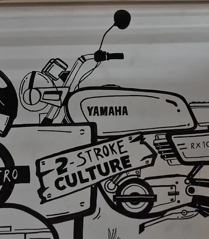 This section of the cafe mural celebrates Bangalore's '2-Stroke Culture' with an illustration of a classic Yamaha RX100 motorcycle. We love incorporating local subcultures into our commercial artwork.