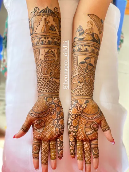 A full bridal design that balances intricate patterns with bold figure work. The doli and baraat scenes on the arms are complemented by dense, detailed patterns on the hands.