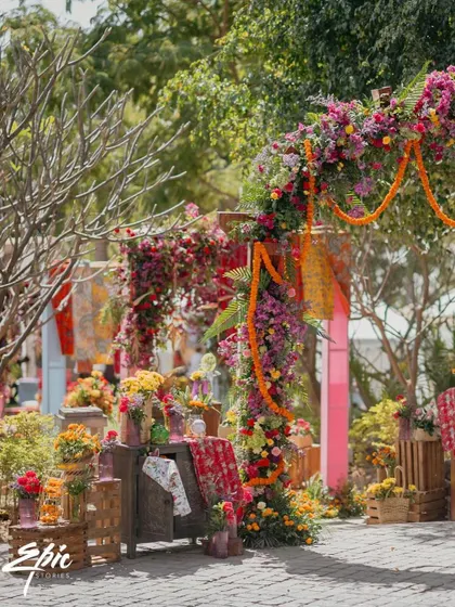 The entrance to our Rajasthani-themed event, where a lush floral arch and marigold garlands welcomed guests into a world of color.