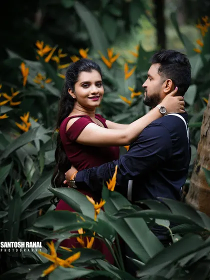 An intimate embrace amidst a field of yellow flowers, creating a vibrant and romantic scene.