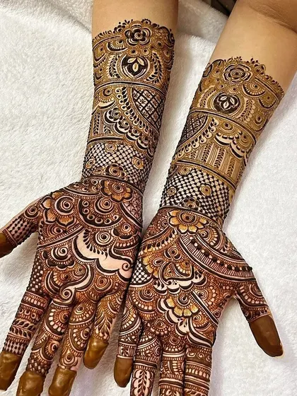 I love playing with different textures in one design. This piece combines checkerboard patterns, delicate dots, and bold floral elements for a visually rich and complex bridal mehendi.
