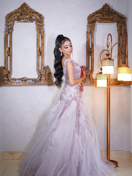 A side view of the lilac gown, highlighting its unique silhouette and detailing.