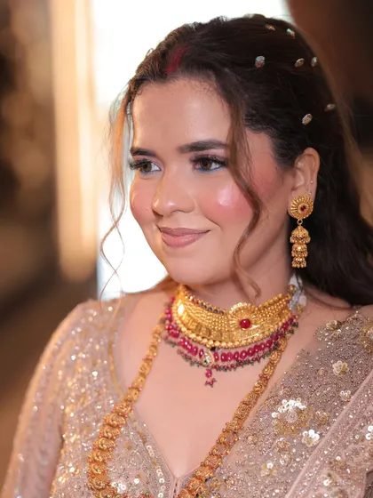My client Vidushi sent me this lovely photo from her engagement. The makeup is soft and rosy, with a traditional touch from the sindoor and gold jewelry.