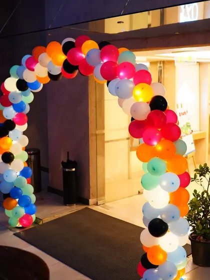 An illuminated balloon arch welcomed guests to Tansh's car-themed birthday party, setting a fun and festive mood from the moment they arrived.