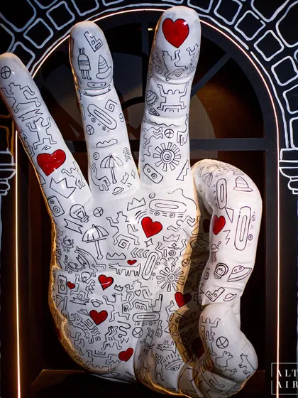 A detail from the Keith Haring-inspired pre-dining room. This hand sculpture, covered in his iconic doodle style, was one of many art pieces that transformed the space into a tribute to the artist.