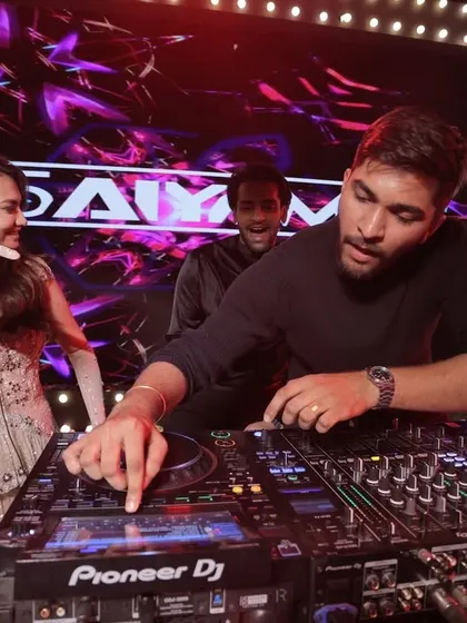 For me, DJing isn't just about playing music; it's about connecting with everyone. Here I am showing the bride the ropes at her own wedding party. It’s these interactive moments that make a celebration unforgettable.