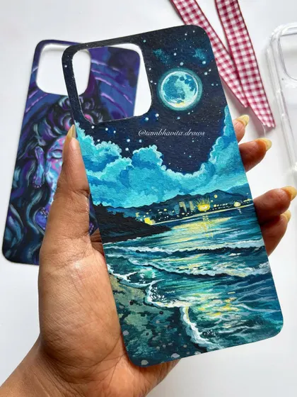 This custom-painted beach scene is one of my absolute favorites. I used acrylics on black paper to capture the glow of the city lights on the water, creating a moody and beautiful piece of art that you can carry with you.