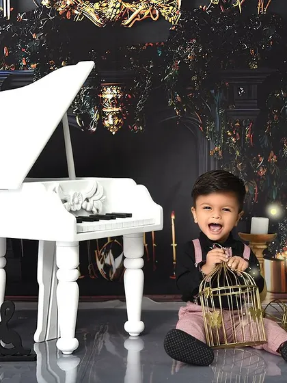 A moment of pure joy and laughter during our piano-themed session. It's these candid shots that truly capture a child's spirit.