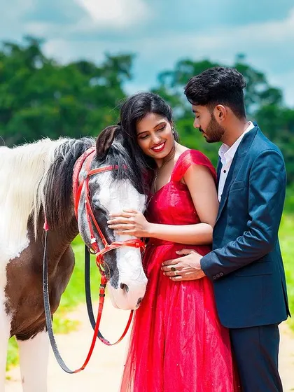 A tender moment between the couple and a horse, adding a touch of rustic charm to their pre-wedding photoshoot.