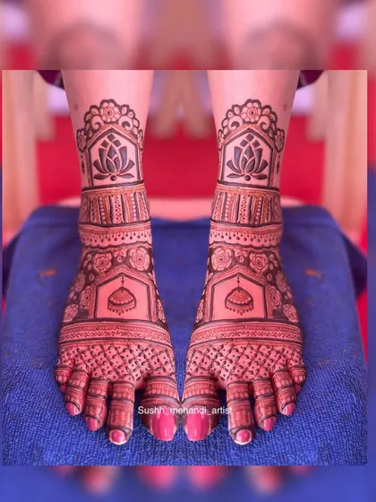 A full view of a symmetrical foot design, featuring lotus flowers and jhumka motifs. The design is perfectly mirrored on both feet.