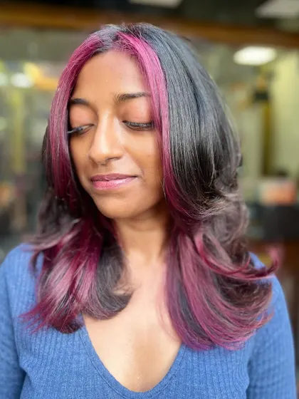 Another beautiful shot of the purple peekaboo highlights, showing how they blend seamlessly with the client's natural hair.