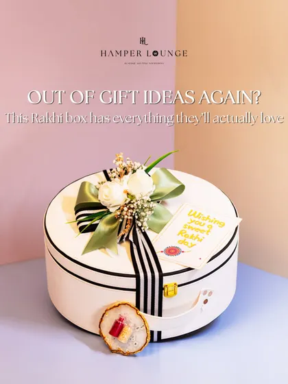 A stylish solution for Rakhi gifting. This luxe white leather round box is filled with self-care items and snacks, making it a modern and memorable gift for your sibling.
