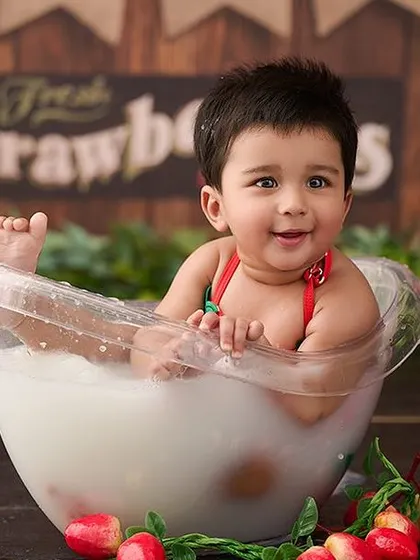 A sweet strawberry-themed milk bath. The red strawberries add a pop of color to the creamy white water, creating a delicious-looking photo.