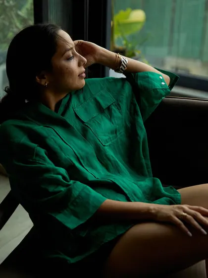 A candid moment of relaxation during a branding shoot in Pune. The natural window light and comfortable pose create an authentic lifestyle portrait.