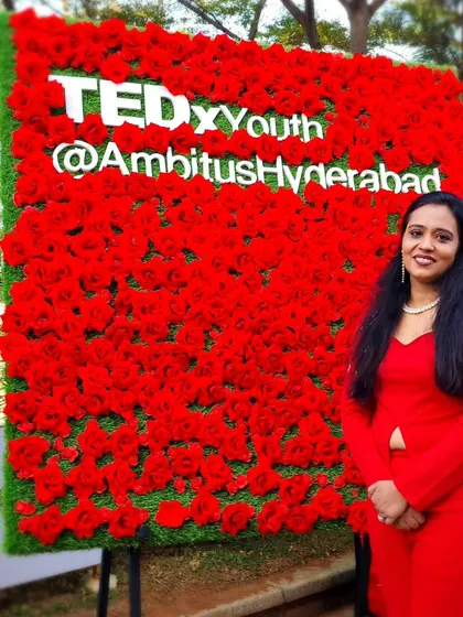 The vibrant red flower wall at TEDxYouth in Hyderabad was a perfect backdrop. It symbolizes the passion and energy I aim to ignite in every person who attends my talks.