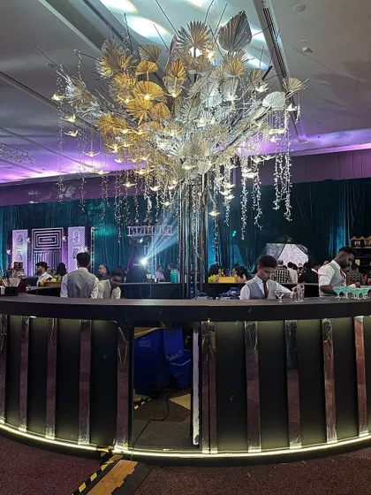 This large, circular bar was the hub of a major corporate event. Its modern design, sleek black finish, and dramatic central chandelier allowed our bartenders to serve a large crowd efficiently and in style.