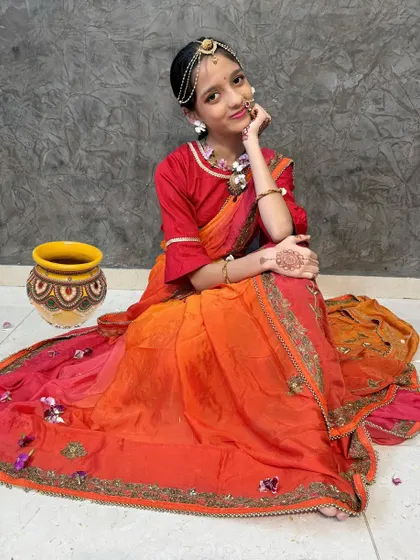 A full view of the Radha look for Janmashtami, complete with a matka. The drape is simple yet elegant.