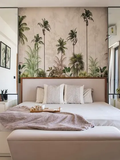 This bedroom is designed as a personal sanctuary. The tropical-themed wallpaper creates a focal point and a sense of escape, while the neutral color palette, clean lines, and soft textures make the room feel calm and restful.