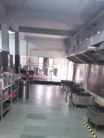A wide view of our commercial kitchen. The layout is spacious and organized to facilitate a smooth workflow for any catering or bulk cooking operation.