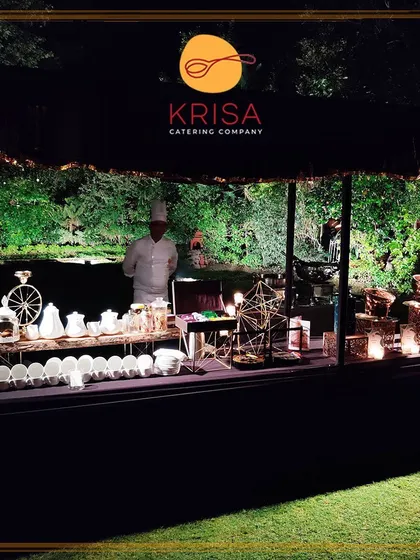 Our catering station set up for an evening event in a garden. The branded stall, professional chef, and elegant tableware create a complete, high-end culinary experience that echoes luxury.